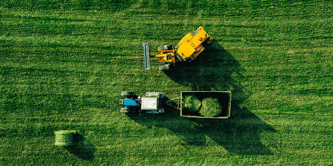 aerial view of harvest field with tractor moving